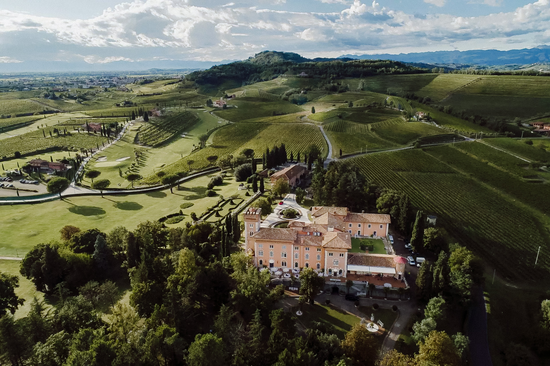 Aerial view of Castello di Spessa surrounded by vineyards and gardens