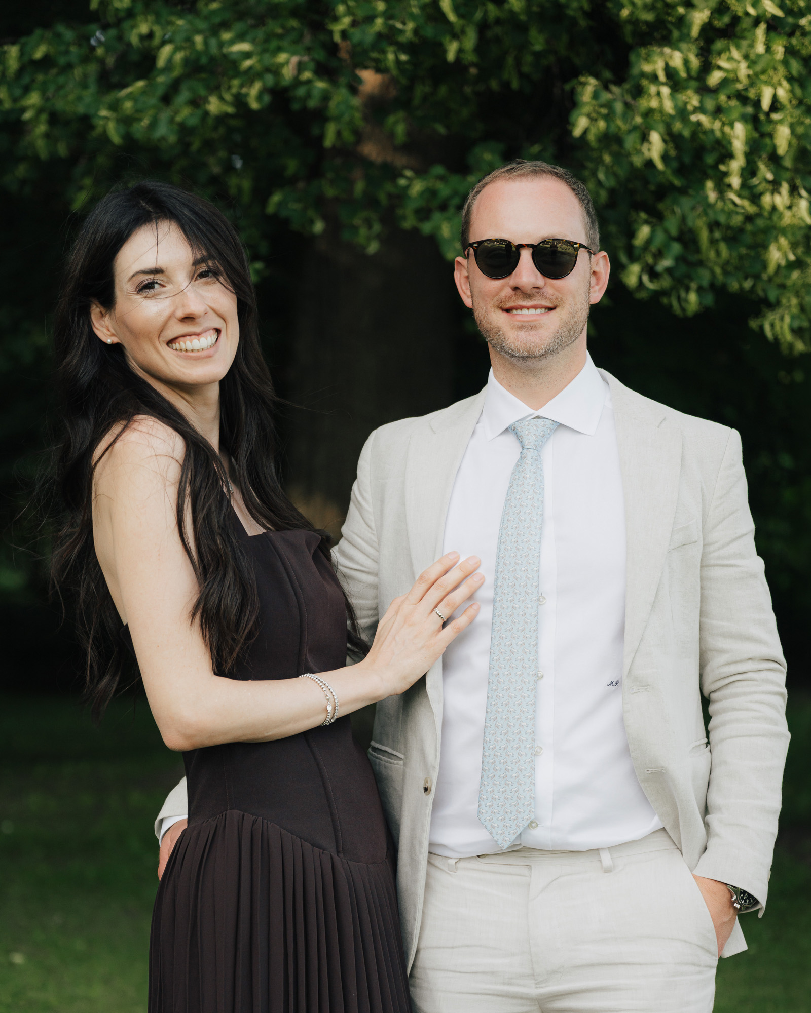 Neža and Miha smiling together in a green garden