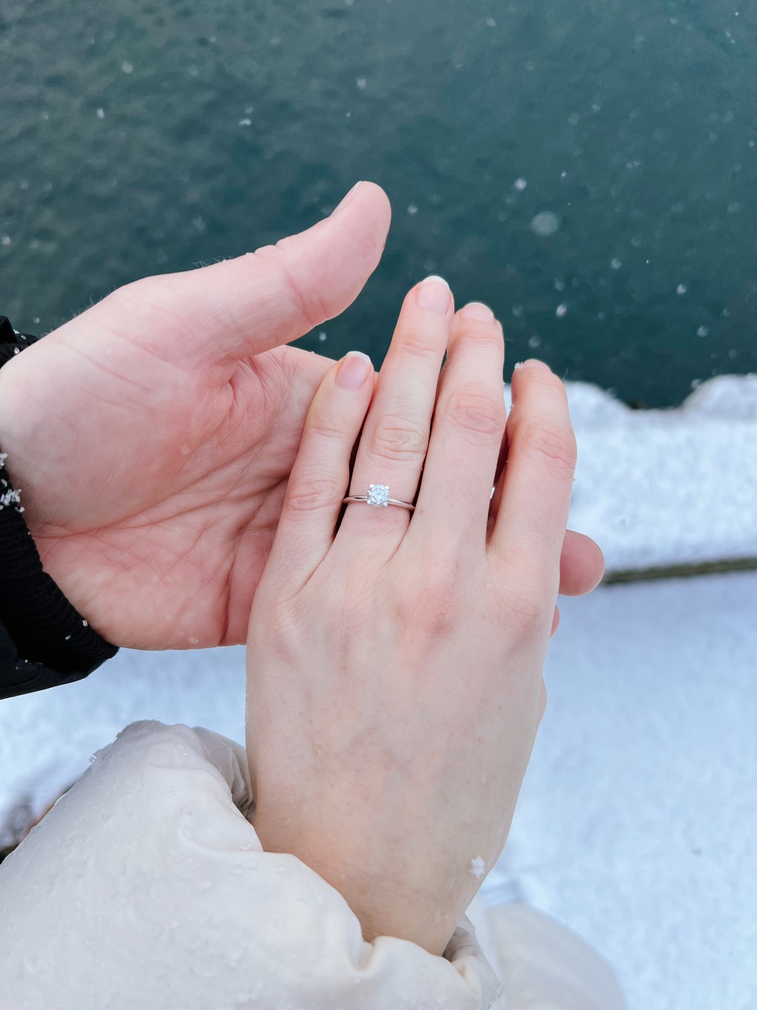Neža's engagement ring as she and Miha hold hands beside the sea